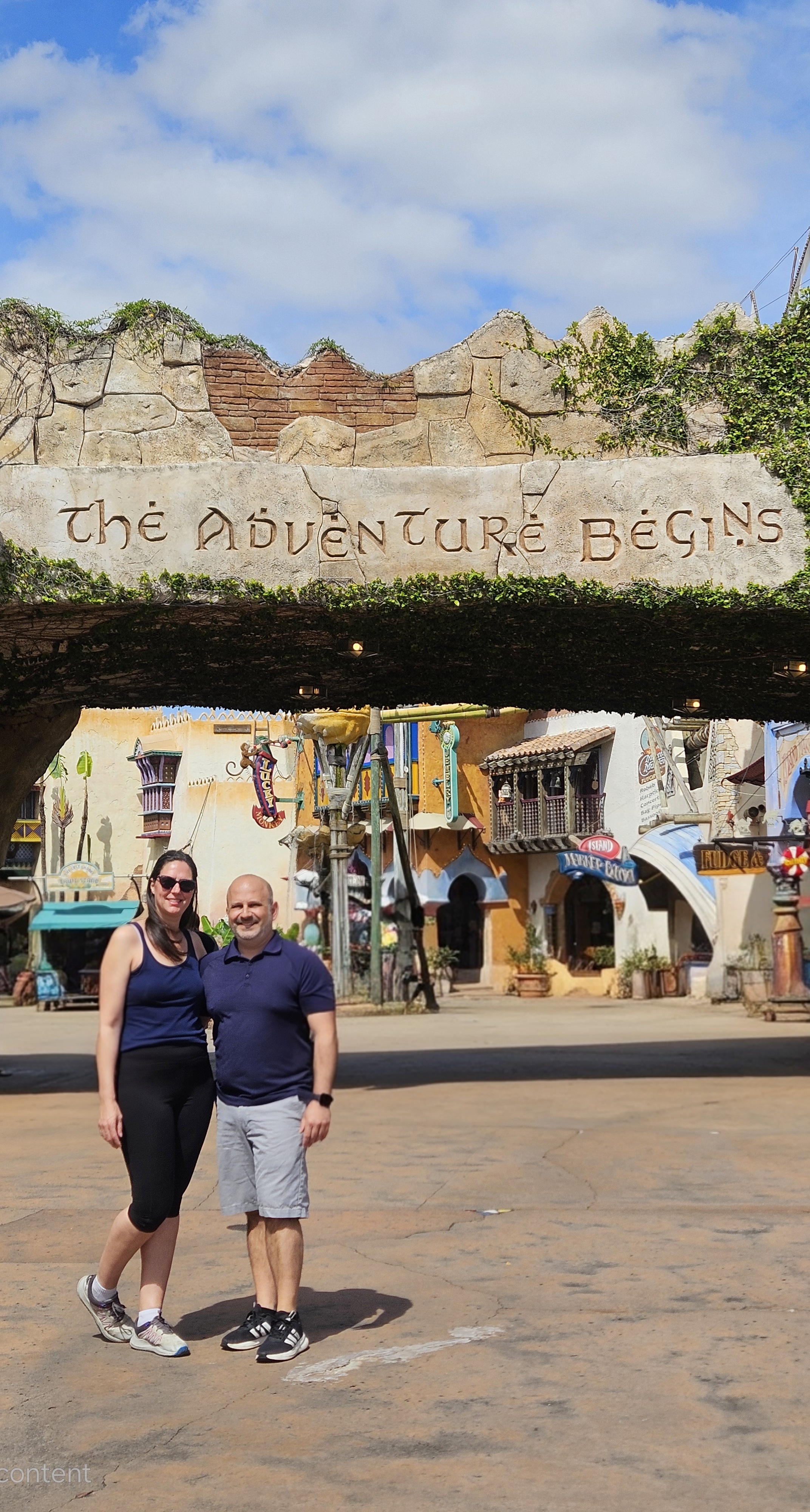 Michele and Daniel at &ldquo;The Adventure Begins&rdquo; sign at Islands of Adventure